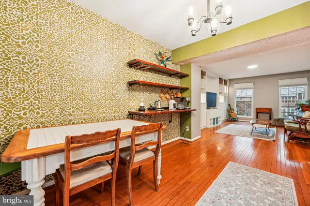 a living room with patio furniture and a wooden floor