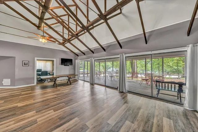 a view of a room with wooden floor and furniture