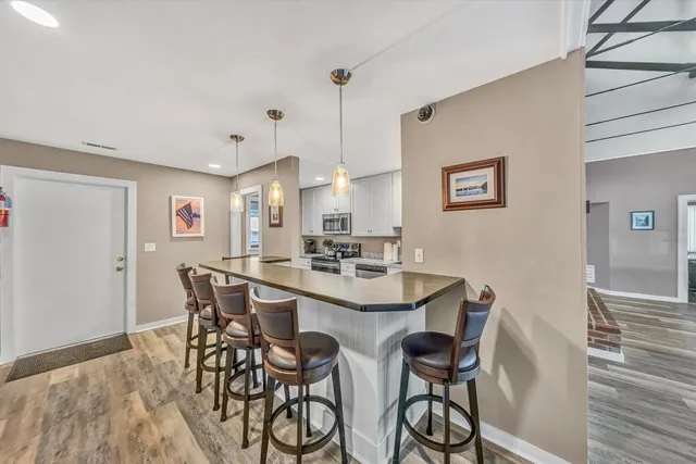a view of a dining room with furniture and wooden floor