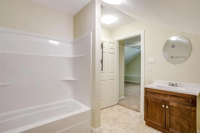 a bathroom with a bathtub and a sink