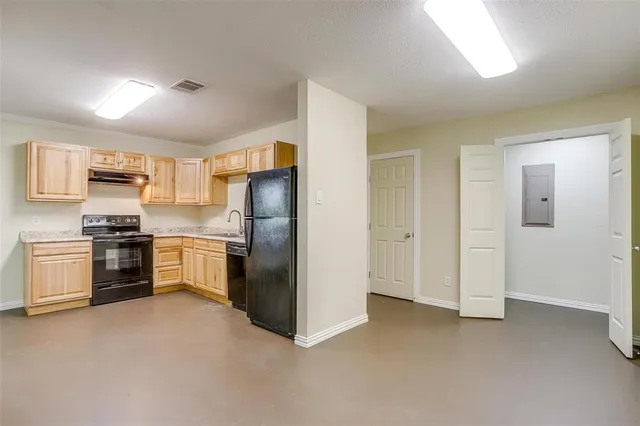 a kitchen with a refrigerator and a sink