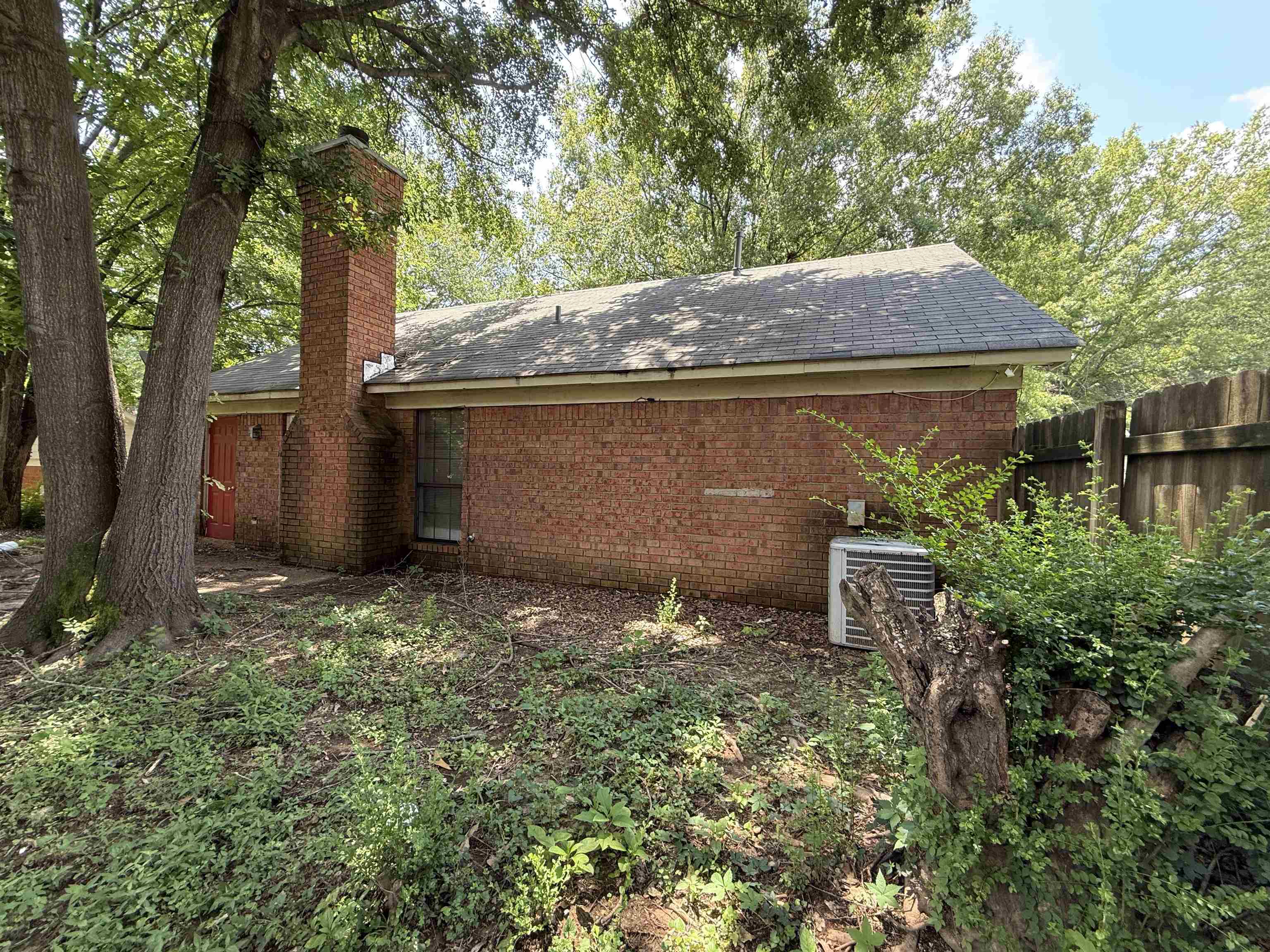 6420 Saginaw Road Memphis, TN 38134 - Photo 37 of 38 Brick exterior featuring a tall chimney and a pitched roof