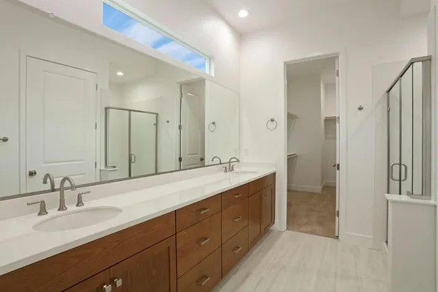 a spacious bathroom with a double vanity sink mirror double and bathtub