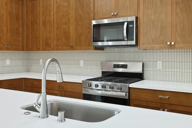 a kitchen with a sink and a stove top oven