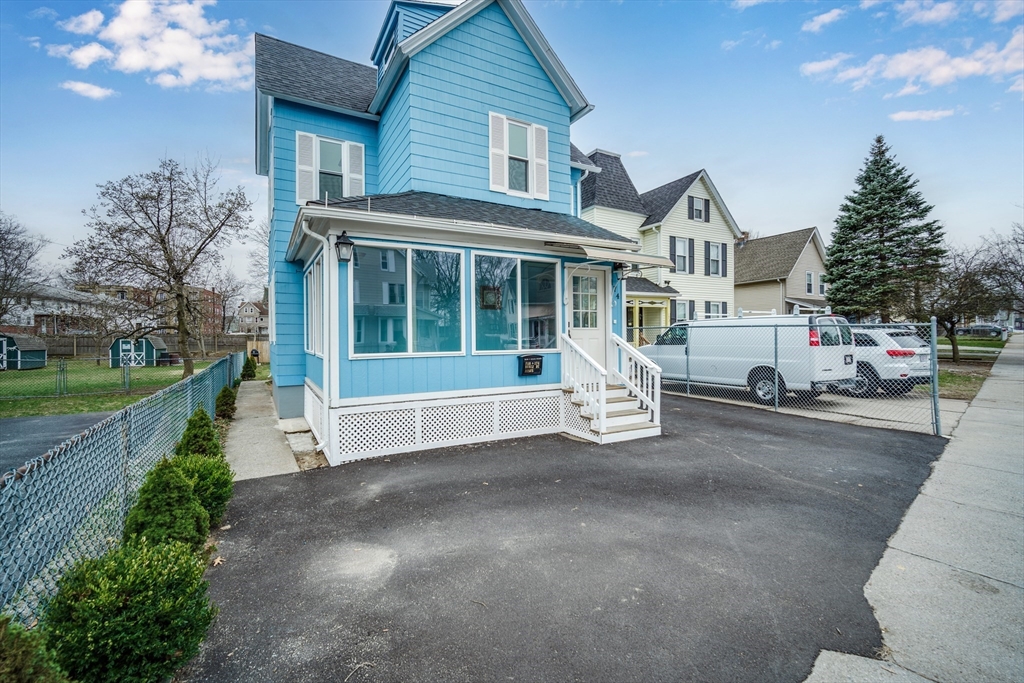 174 Allen Street Springfield, MA 01108 - Photo 1 of 37 a front view of a house with a garden and plants