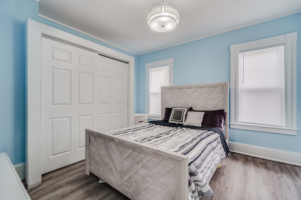 174 Allen Street Springfield, MA 01108 - Photo 12 of 37 a bed sitting in a bedroom next to a window