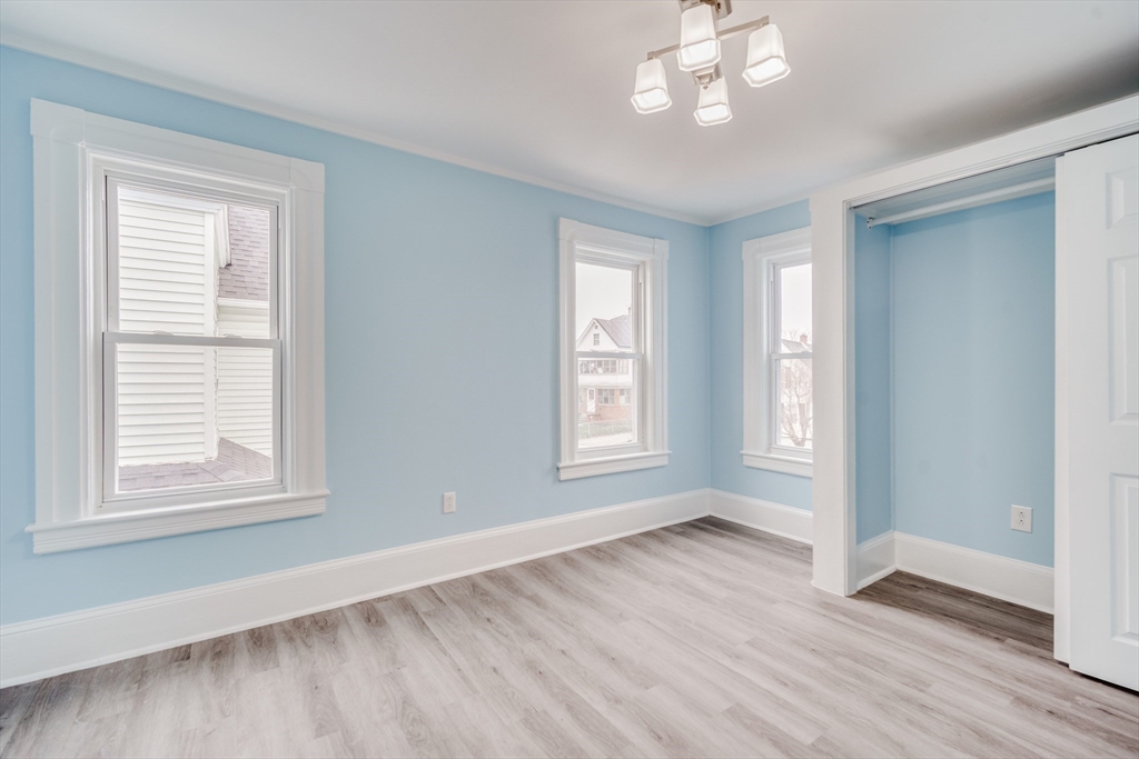 174 Allen Street Springfield, MA 01108 - Photo 14 of 37 a view of an empty room with wooden floor and a window
