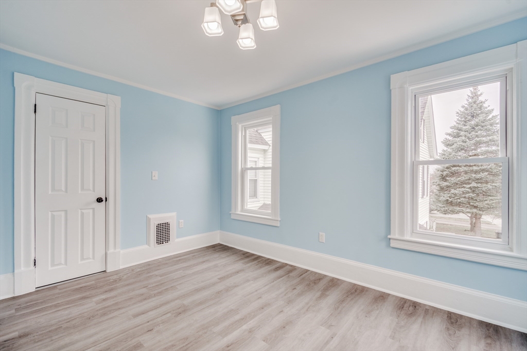174 Allen Street Springfield, MA 01108 - Photo 15 of 37 a view of an empty room with wooden floor and a window