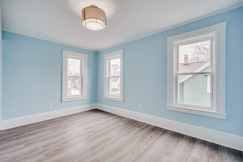 174 Allen Street Springfield, MA 01108 - Photo 16 of 37 a view of an empty room with wooden floor and a window