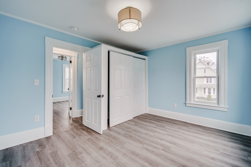 174 Allen Street Springfield, MA 01108 - Photo 17 of 37 an empty room with wooden floor and window