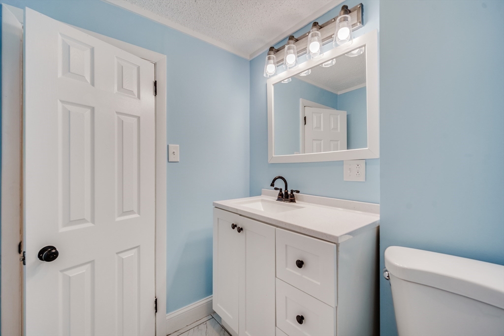 174 Allen Street Springfield, MA 01108 - Photo 19 of 37 a bathroom with a sink a toilet and a mirror
