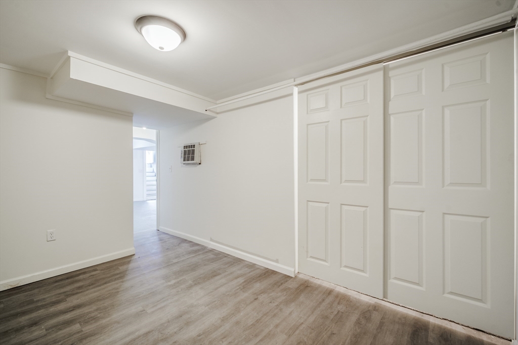 174 Allen Street Springfield, MA 01108 - Photo 29 of 37 an empty room with wooden floor and closet area