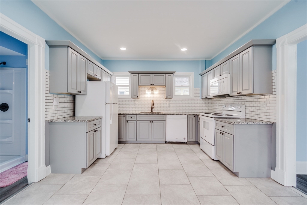174 Allen Street Springfield, MA 01108 - Photo 3 of 37 a kitchen with granite countertop cabinets and stainless steel appliances
