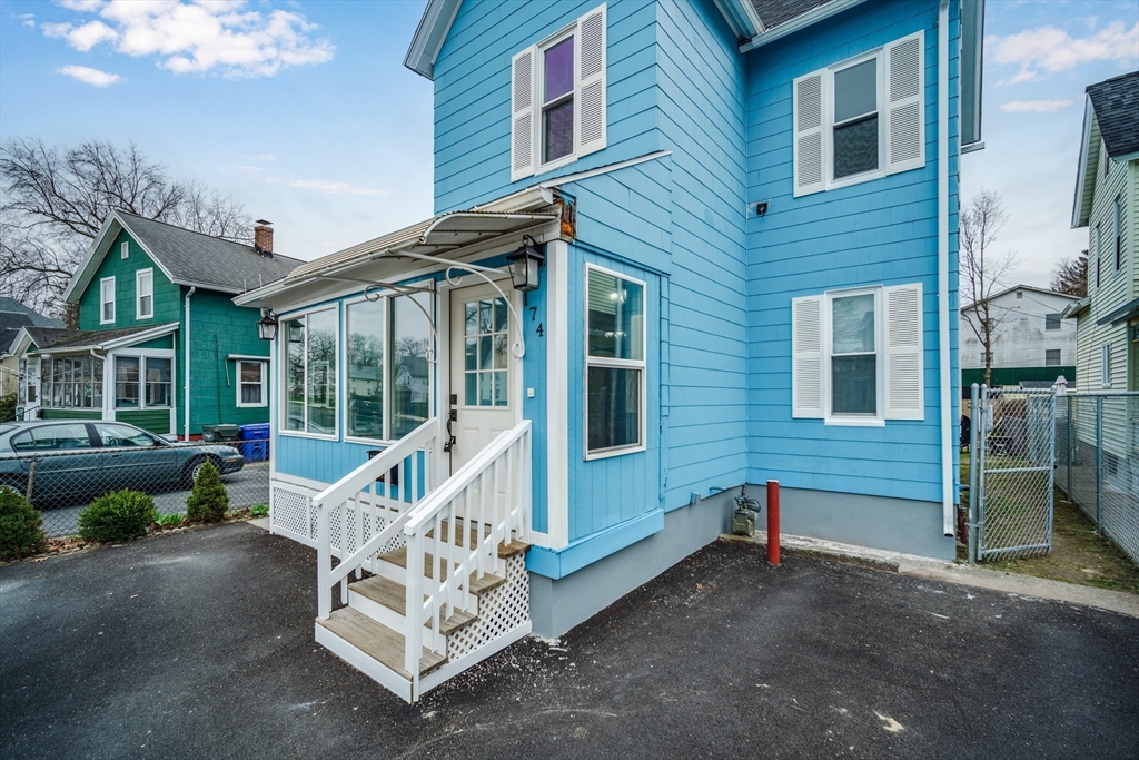 174 Allen Street Springfield, MA 01108 - Photo 37 of 37 a view of a house with a small deck and a floor to ceiling window