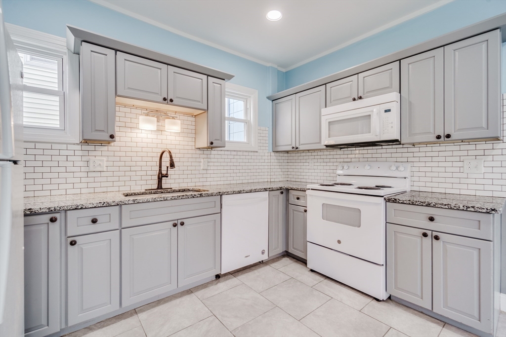 174 Allen Street Springfield, MA 01108 - Photo 6 of 37 a kitchen with white cabinets sink and appliances