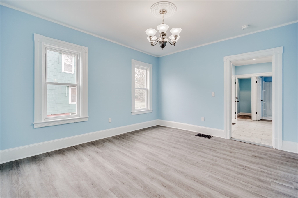 174 Allen Street Springfield, MA 01108 - Photo 7 of 37 a view of an empty room with wooden floor and a window