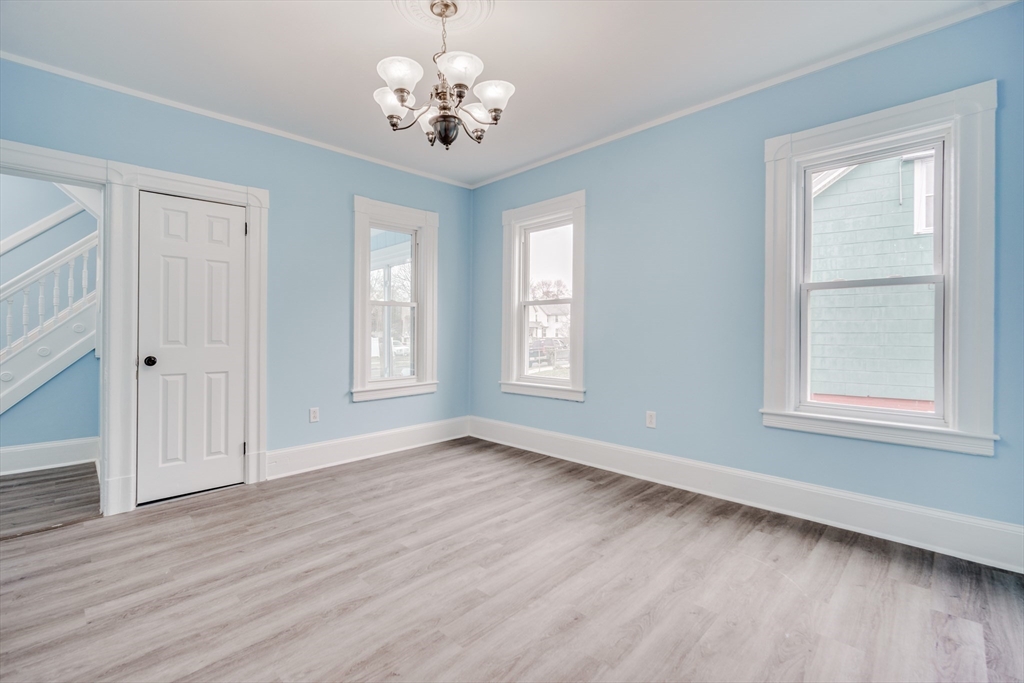 174 Allen Street Springfield, MA 01108 - Photo 8 of 37 a view of an empty room with a window and wooden floor