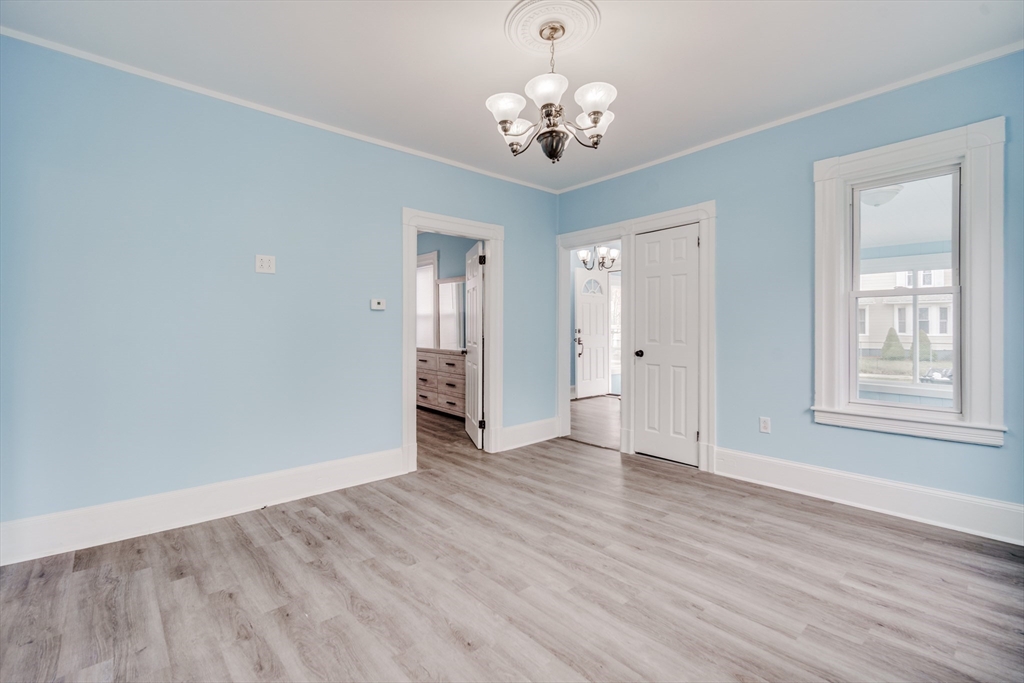 174 Allen Street Springfield, MA 01108 - Photo 9 of 37 a view of an empty room with wooden floor and a window