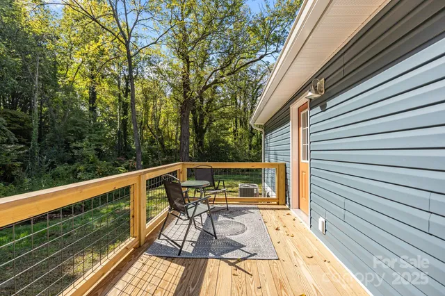 a view of balcony with wooden floor and fence