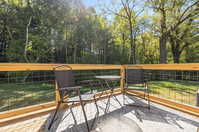a view of a swimming pool with a patio and a yard