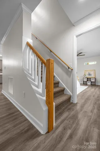 a view of entryway and hall with wooden floor