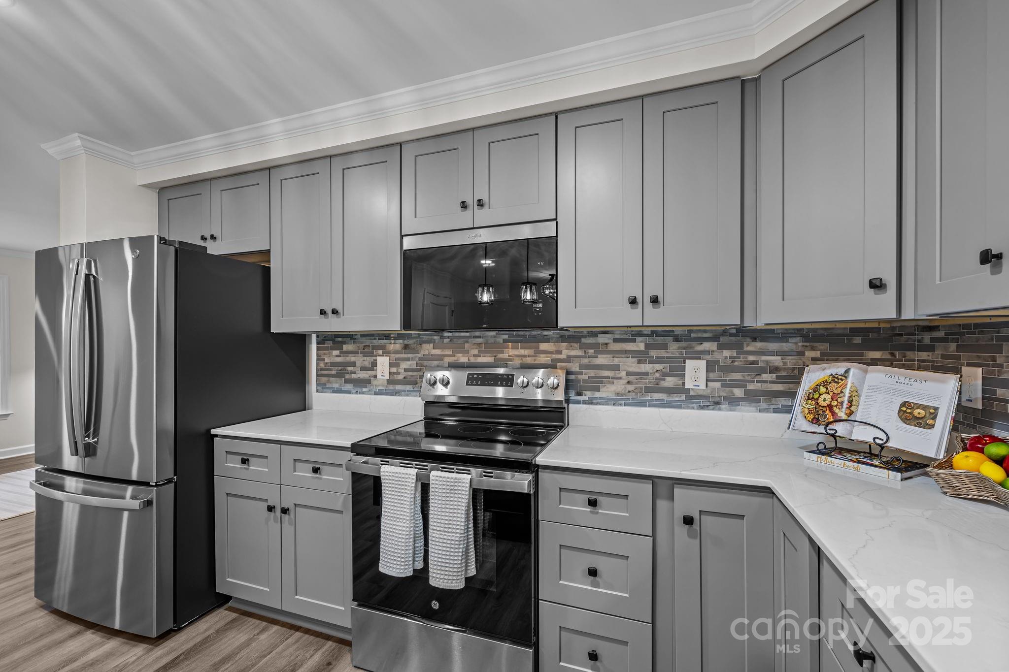 215 McCoy Cove Road Black Mountain, NC 28711 - Photo 19 of 42 a kitchen with refrigerator a stove and a sink