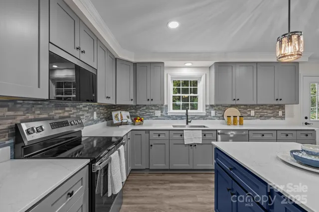 a kitchen with a sink stove and microwave