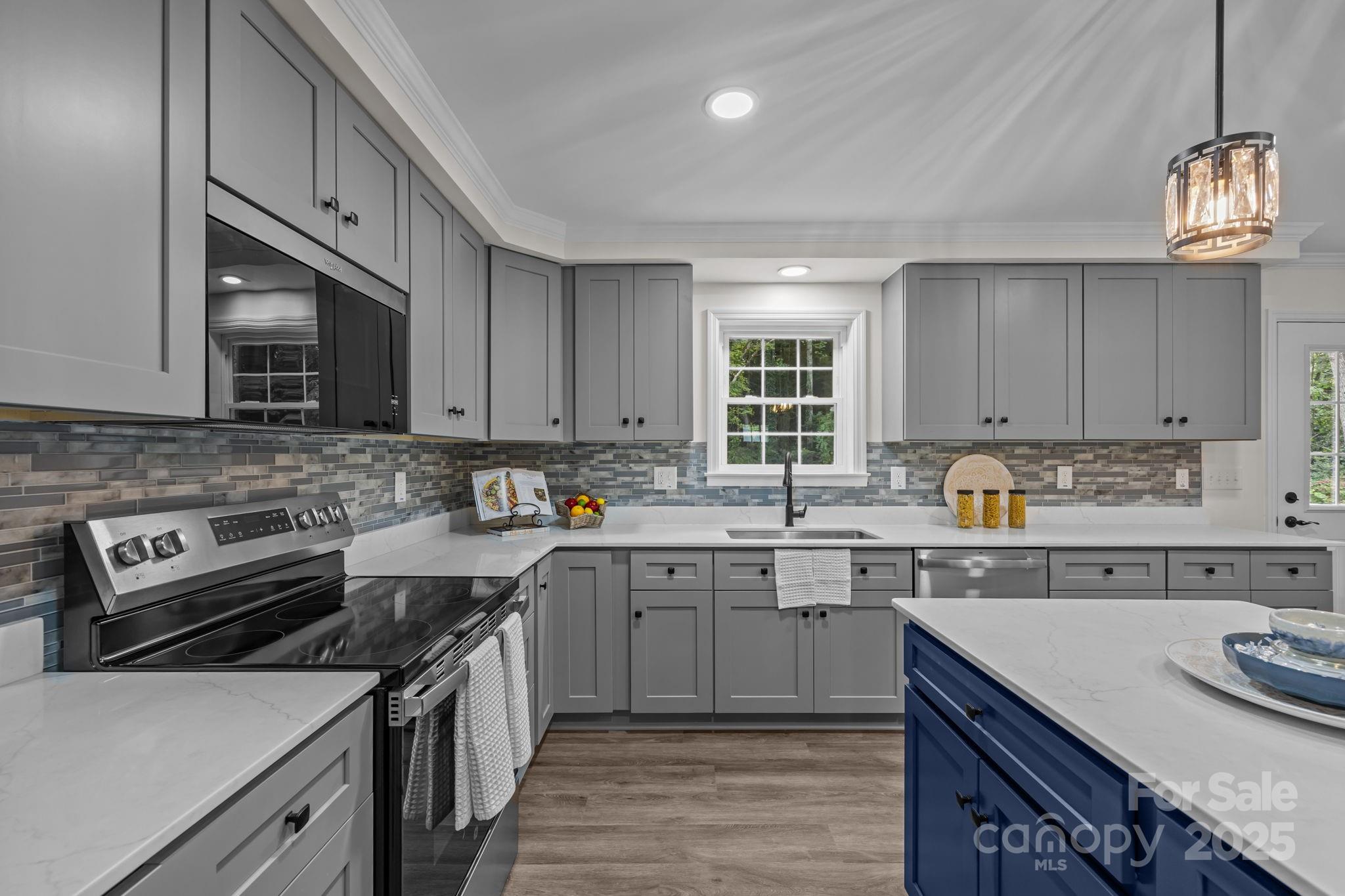 215 McCoy Cove Road Black Mountain, NC 28711 - Photo 20 of 42 a kitchen with a sink stove and microwave