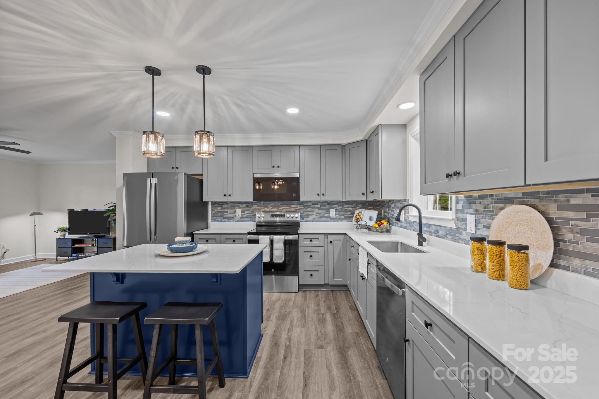 215 McCoy Cove Road Black Mountain, NC 28711 - Photo 21 of 42 a kitchen with kitchen island a wooden floor and white appliances