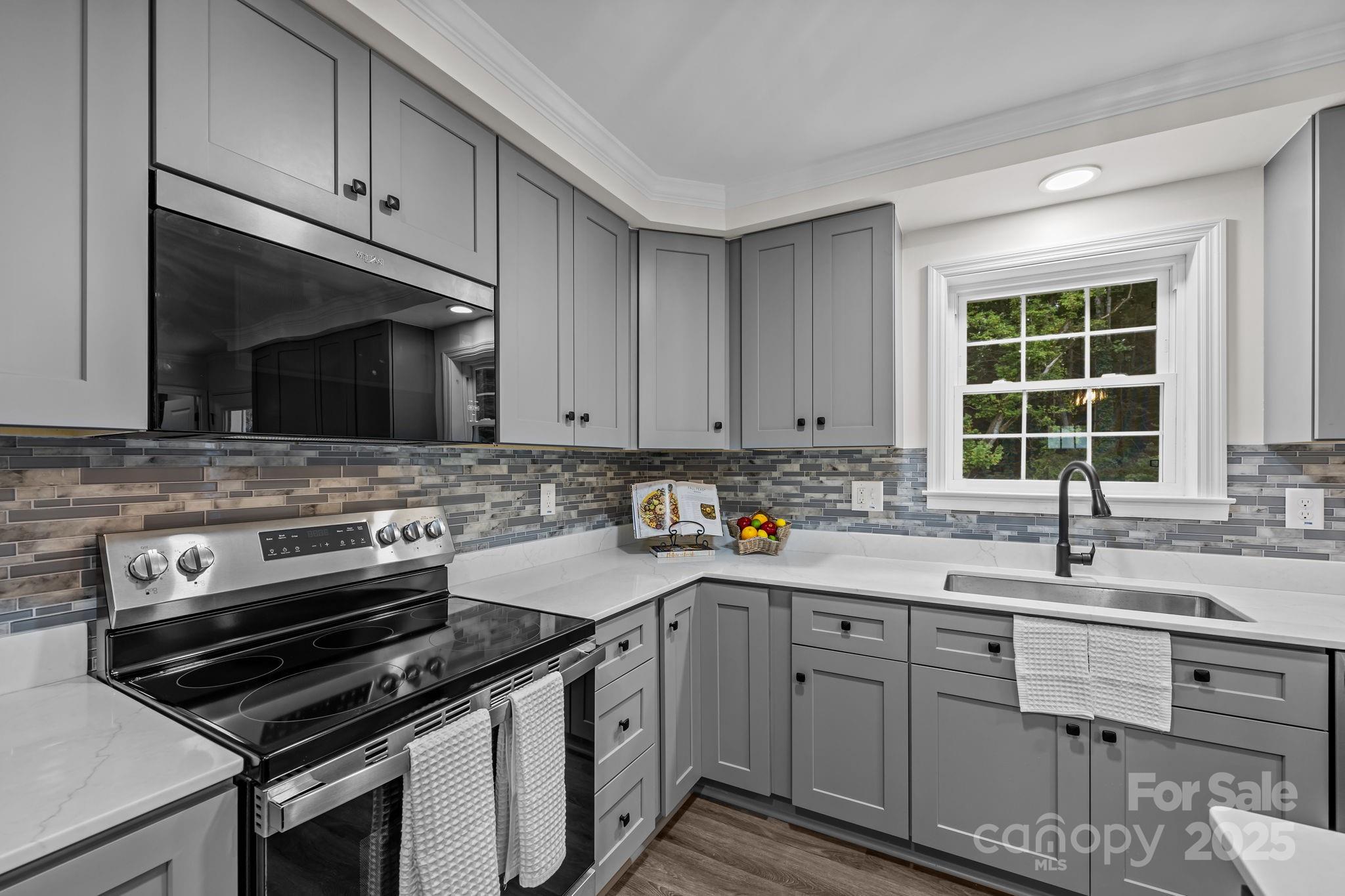 215 McCoy Cove Road Black Mountain, NC 28711 - Photo 22 of 42 a kitchen with a sink stove top oven and cabinets