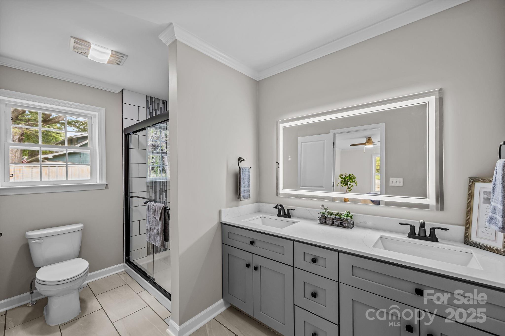 215 McCoy Cove Road Black Mountain, NC 28711 - Photo 28 of 42 a bathroom with double vanity sink a mirror and a toilet