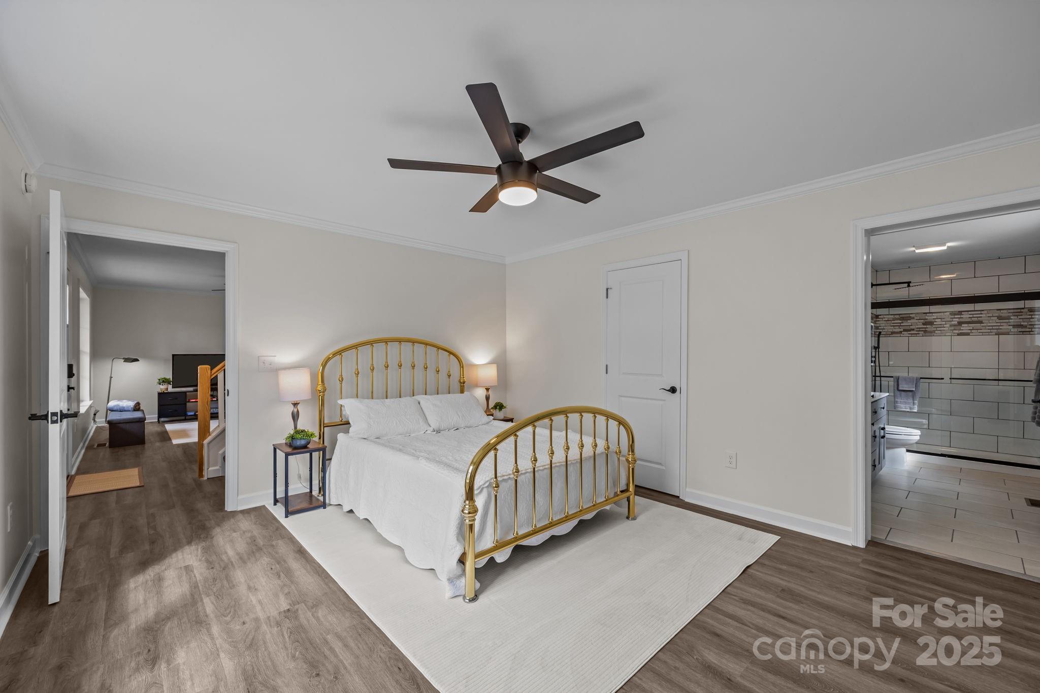 215 McCoy Cove Road Black Mountain, NC 28711 - Photo 30 of 42 a living room with a bed furniture and a wooden floor