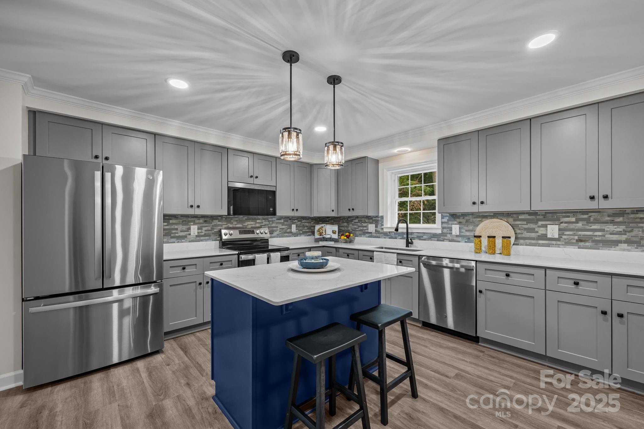 215 McCoy Cove Road Black Mountain, NC 28711 - Photo 3 of 42 a kitchen with refrigerator a sink dishwasher a stove a dining table and chairs