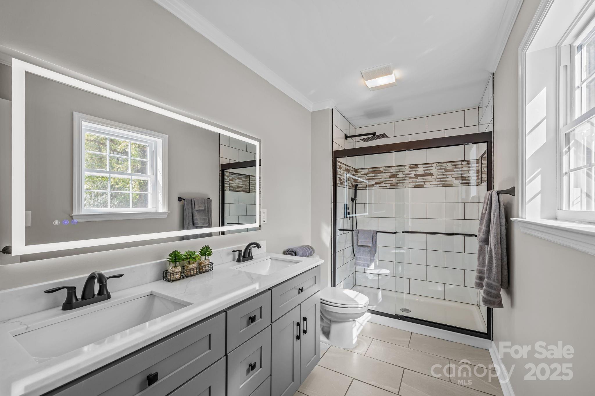 215 McCoy Cove Road Black Mountain, NC 28711 - Photo 32 of 42 a bathroom with a double vanity sink toilet and shower