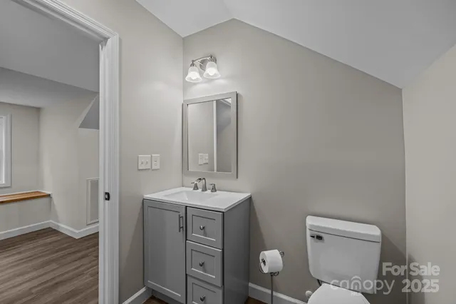 a bathroom with a toilet a sink and mirror