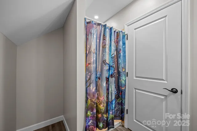 a view of walk in closet with clothes