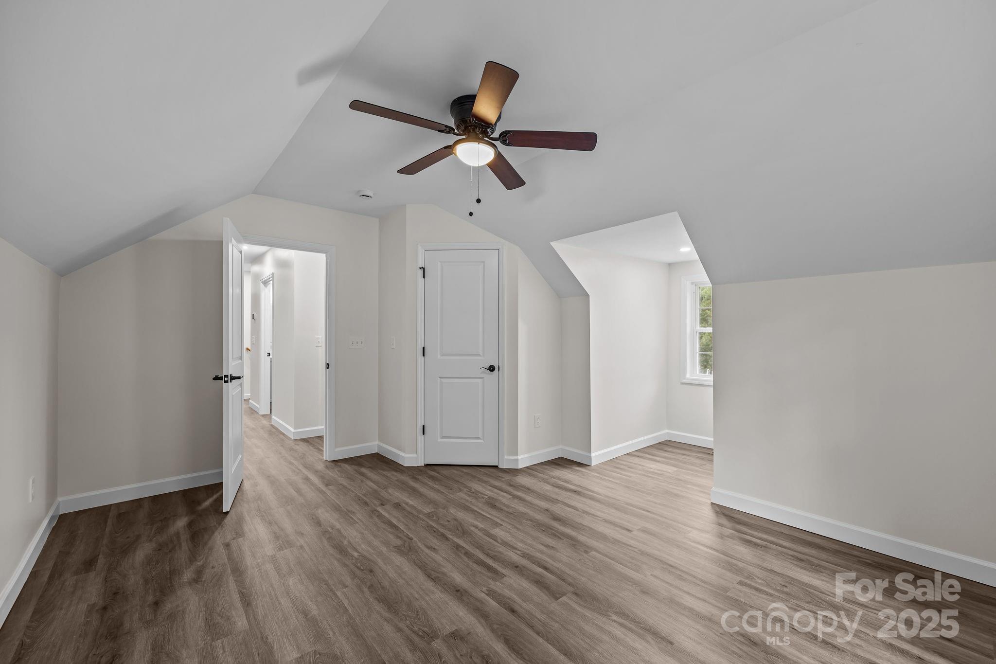 215 McCoy Cove Road Black Mountain, NC 28711 - Photo 39 of 42 an empty room with wooden floor cabinet and windows