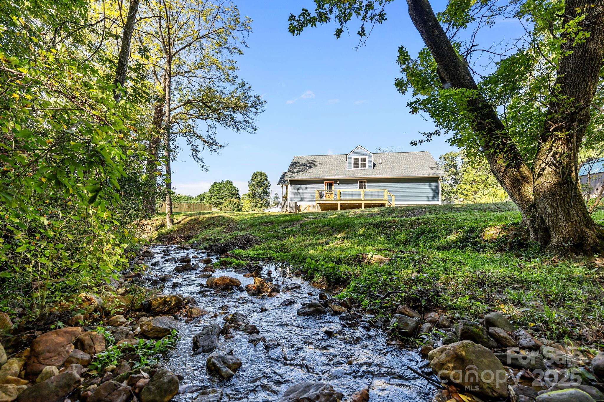 215 McCoy Cove Road Black Mountain, NC 28711 - Photo 5 of 42 a backyard of a house with lots of green space