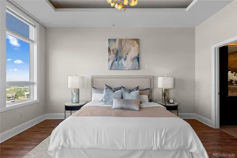 a bedroom with bed and painting on the wall