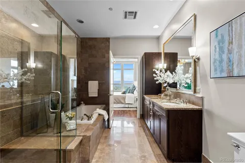 a kitchen with stainless steel appliances granite countertop a refrigerator a sink a stove and a wooden floors