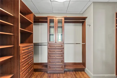 a view of walk in closet with empty racks