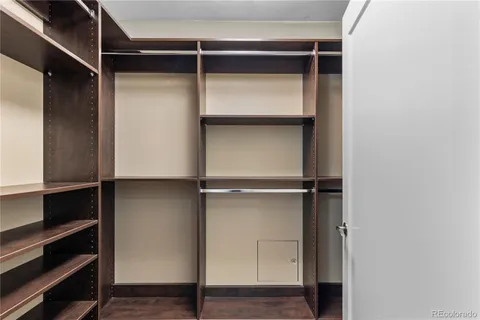 a view of walk in closet with empty racks