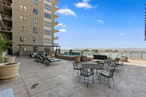 a view of a terrace with furniture and a fire pit