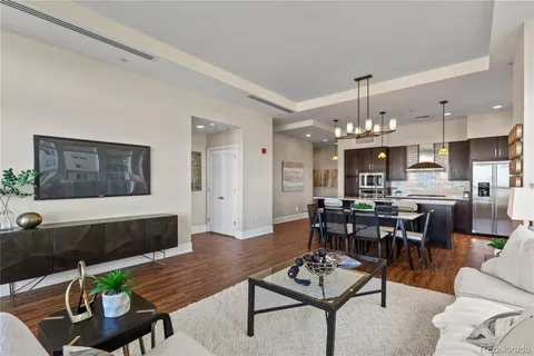 a living room with furniture and a chandelier