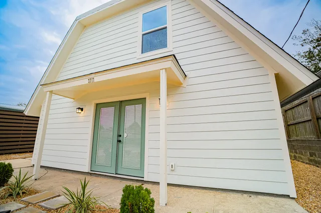 a table with wine bottles and glasses on it
