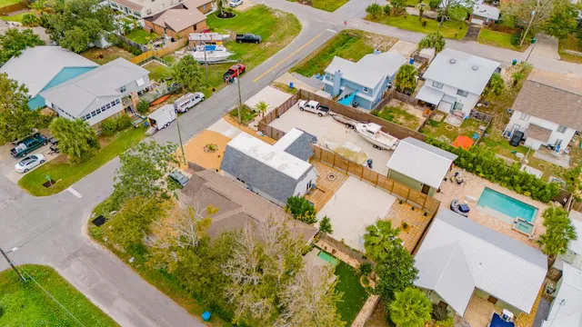 an aerial view of house with a yard and swimming pool