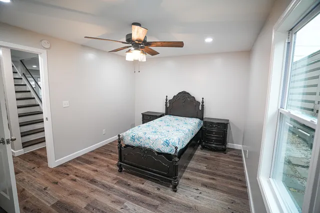 a bedroom with a bed and a chandelier