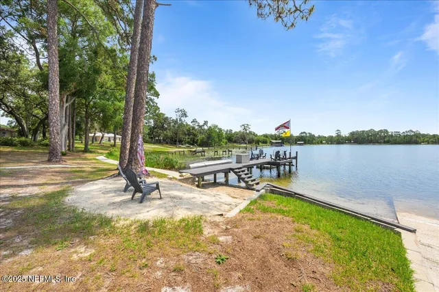 a view of a swimming pool with a patio and a yard