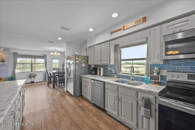 a kitchen with lots of counter top space and wooden floor