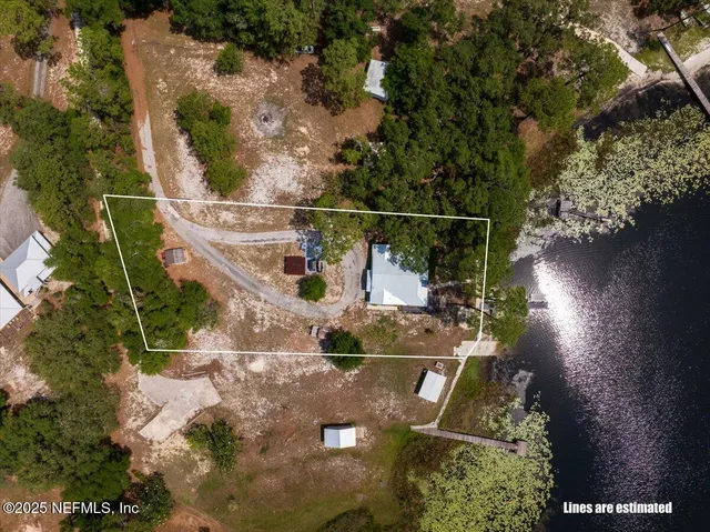 an aerial view of a house with a yard